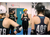 Faith Cortright speaking with Philly Roller Derby Juniors team members at a practice
